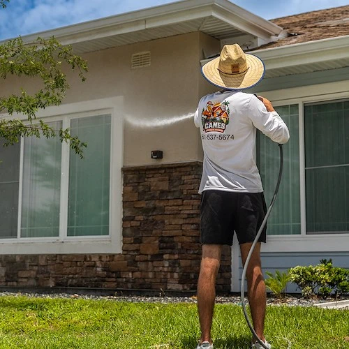 Canes technician washing a Palm Beach County home